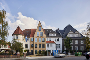  Die Gesamtansicht der Häusergruppe in der Dechaneistraße in Münster; mittig ist der 2020 fertiggestellte Neubau von Mensen + Zora Architekten zu sehen. 